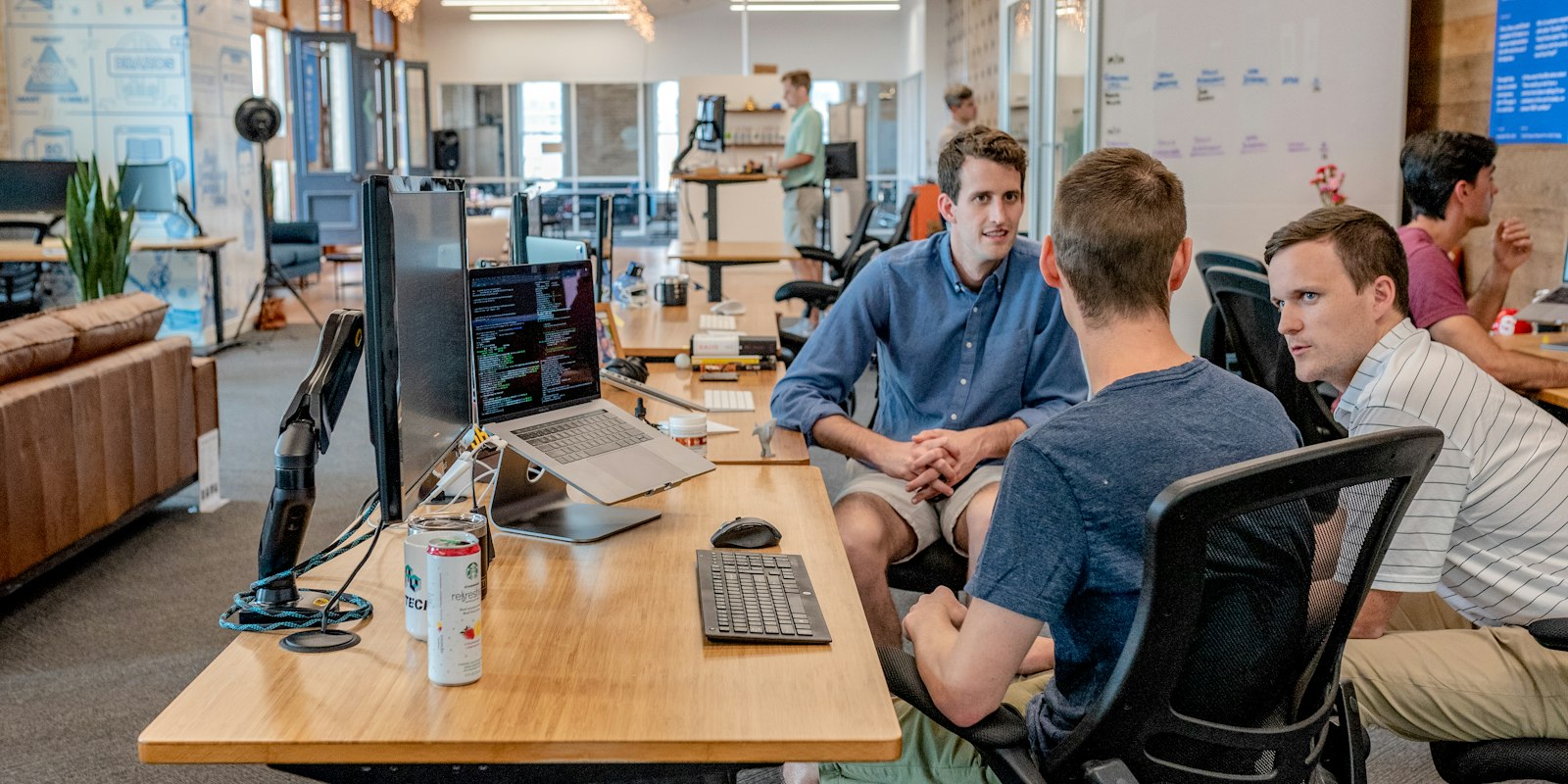 Sales team working together at computers in an office