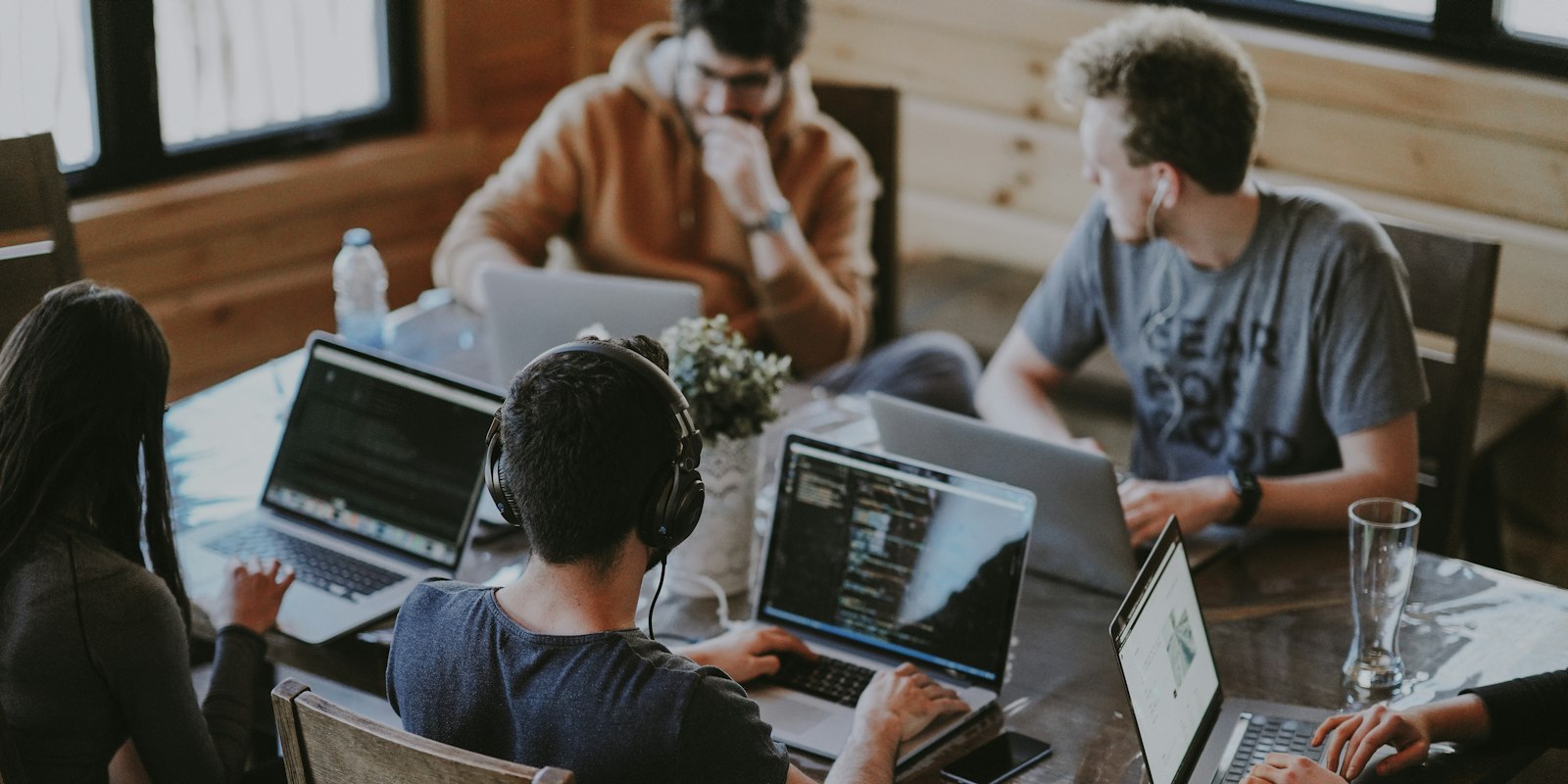Group of people collaborating on laptops