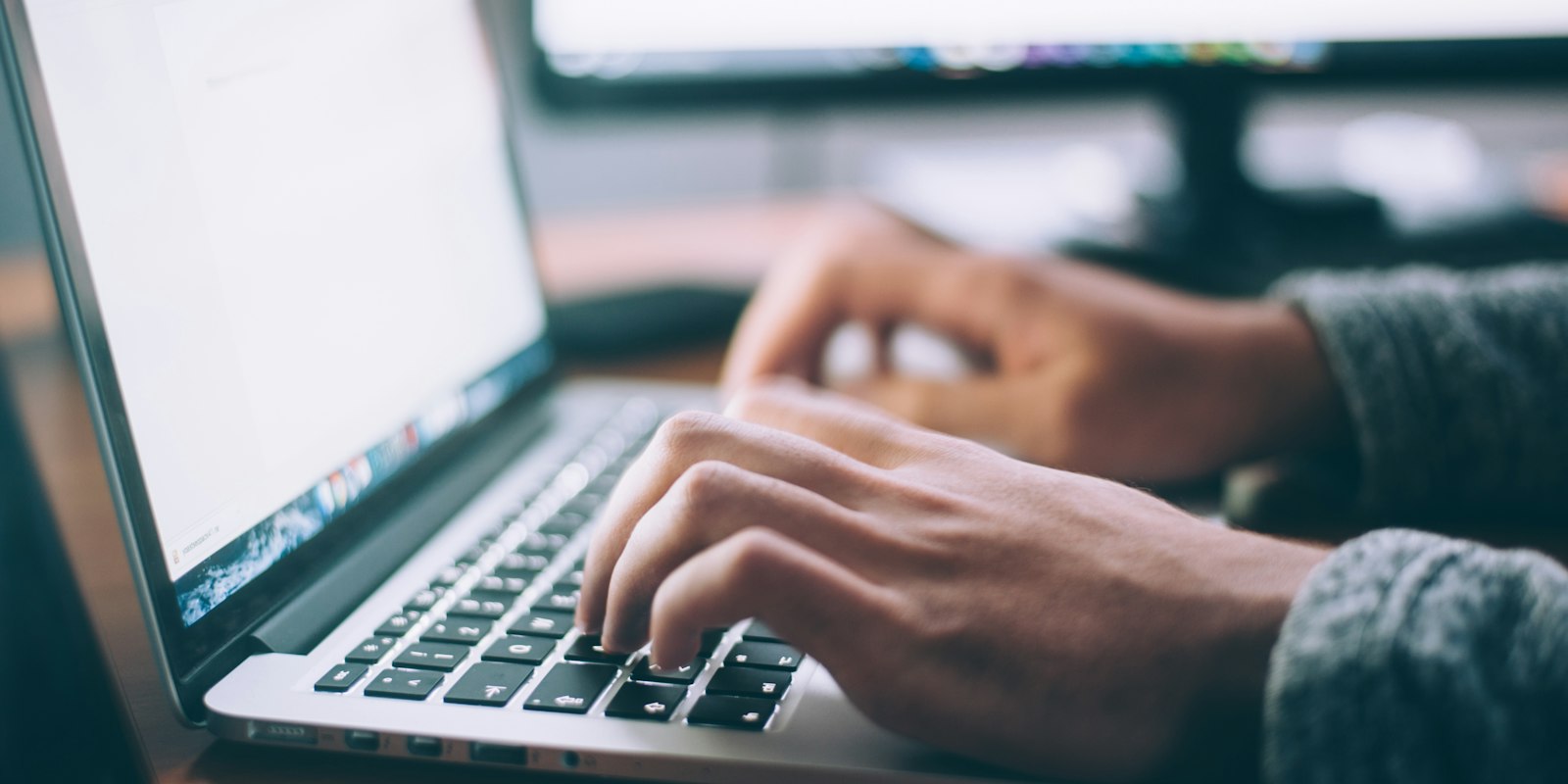 Person working on a laptop at a desk