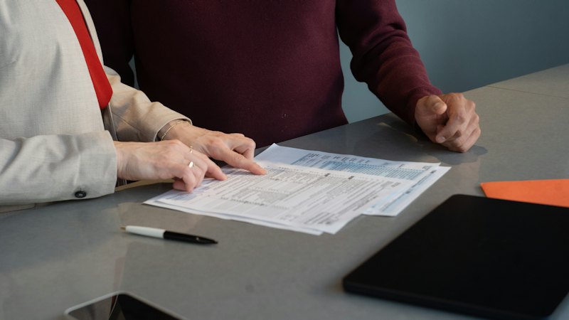 Two people reviewing documents at a table
