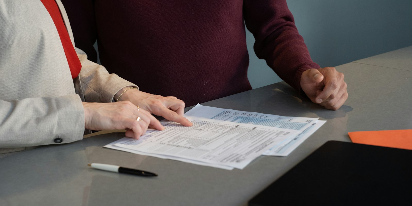 Two people reviewing documents at a table